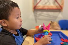 kid-playing-with-playdough